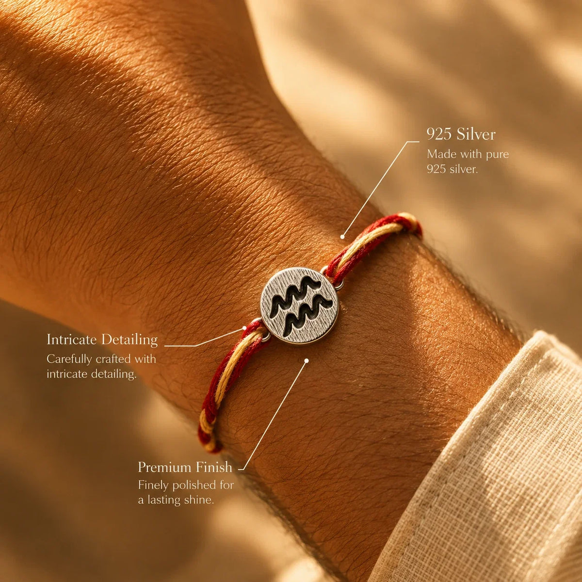 925 silver Aquarius zodiac rakhi on a red and gold braided thread
