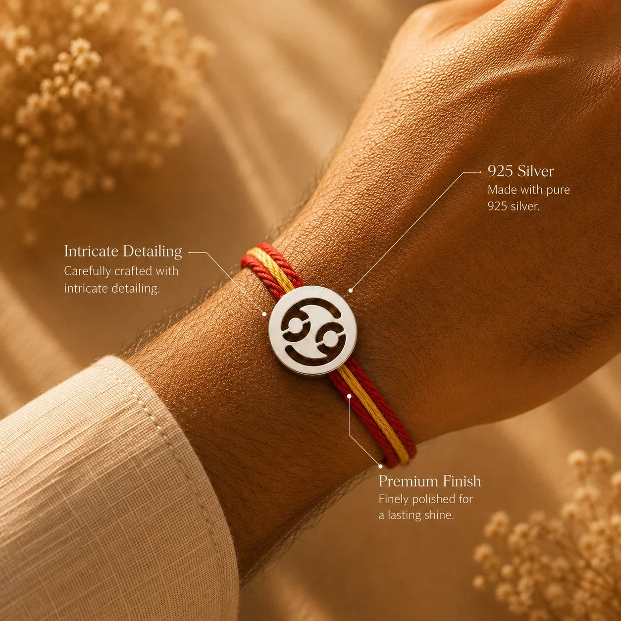 925 silver Cancer zodiac rakhi on a red and gold braided thread