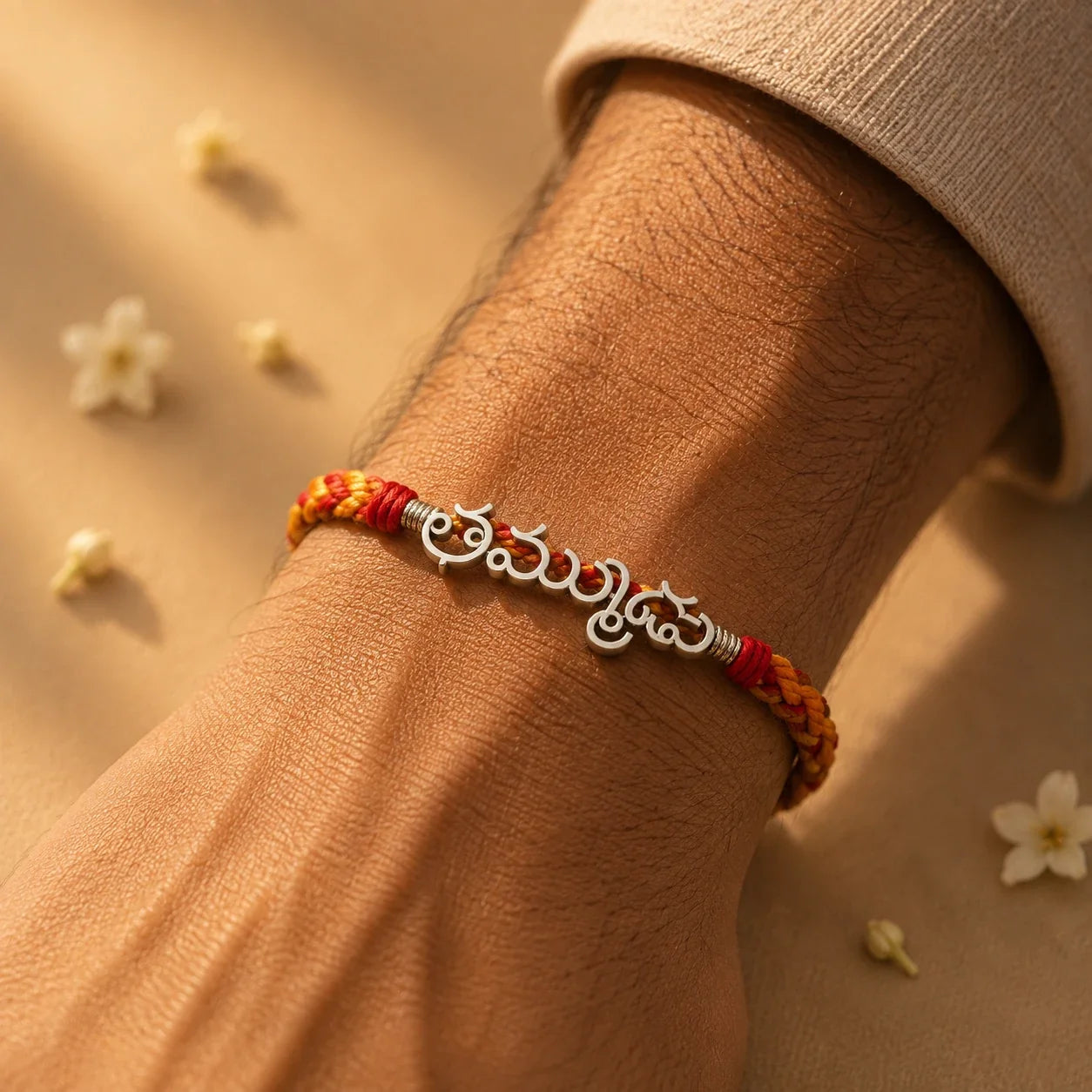 925 silver Telugu Thammudu rakhi with తమ్ముడు engraved in Telugu script on a red braided thread